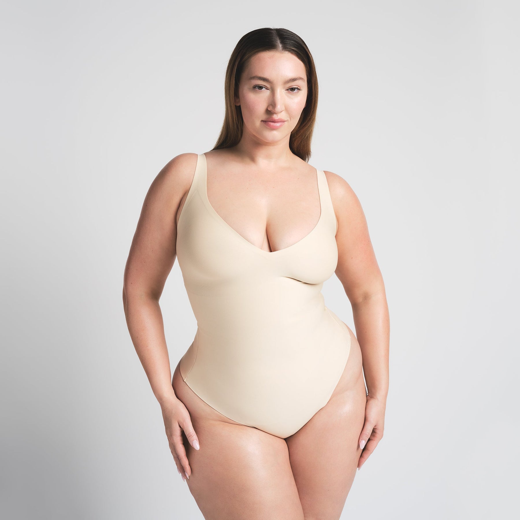 SKIMS BODY UNLINED PLUNGE THONG BODYSUIT | SAND